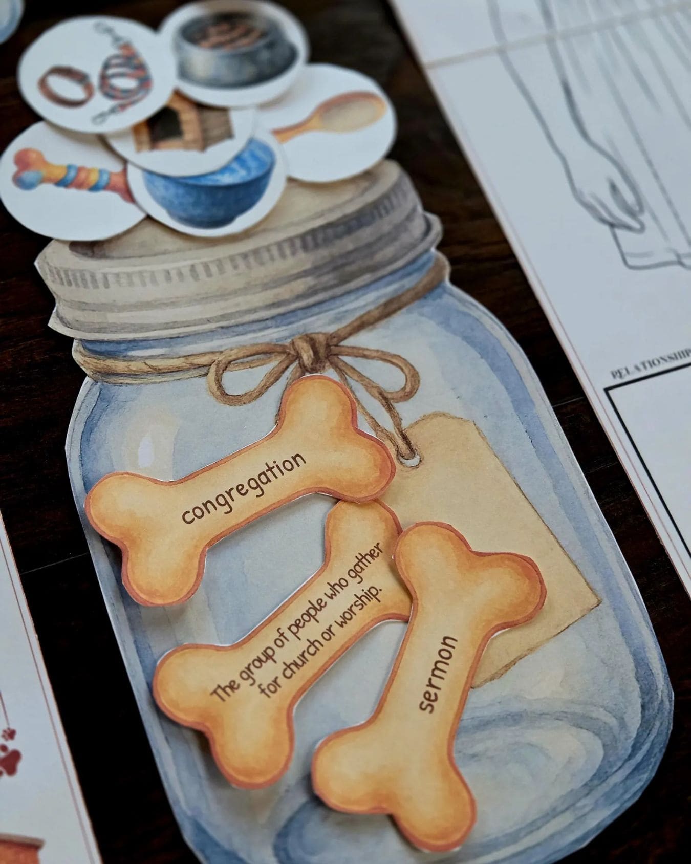 Close-up of the dog bone vocabulary jar printable with words like congregation and sermon from the Winn-Dixie homeschool unit