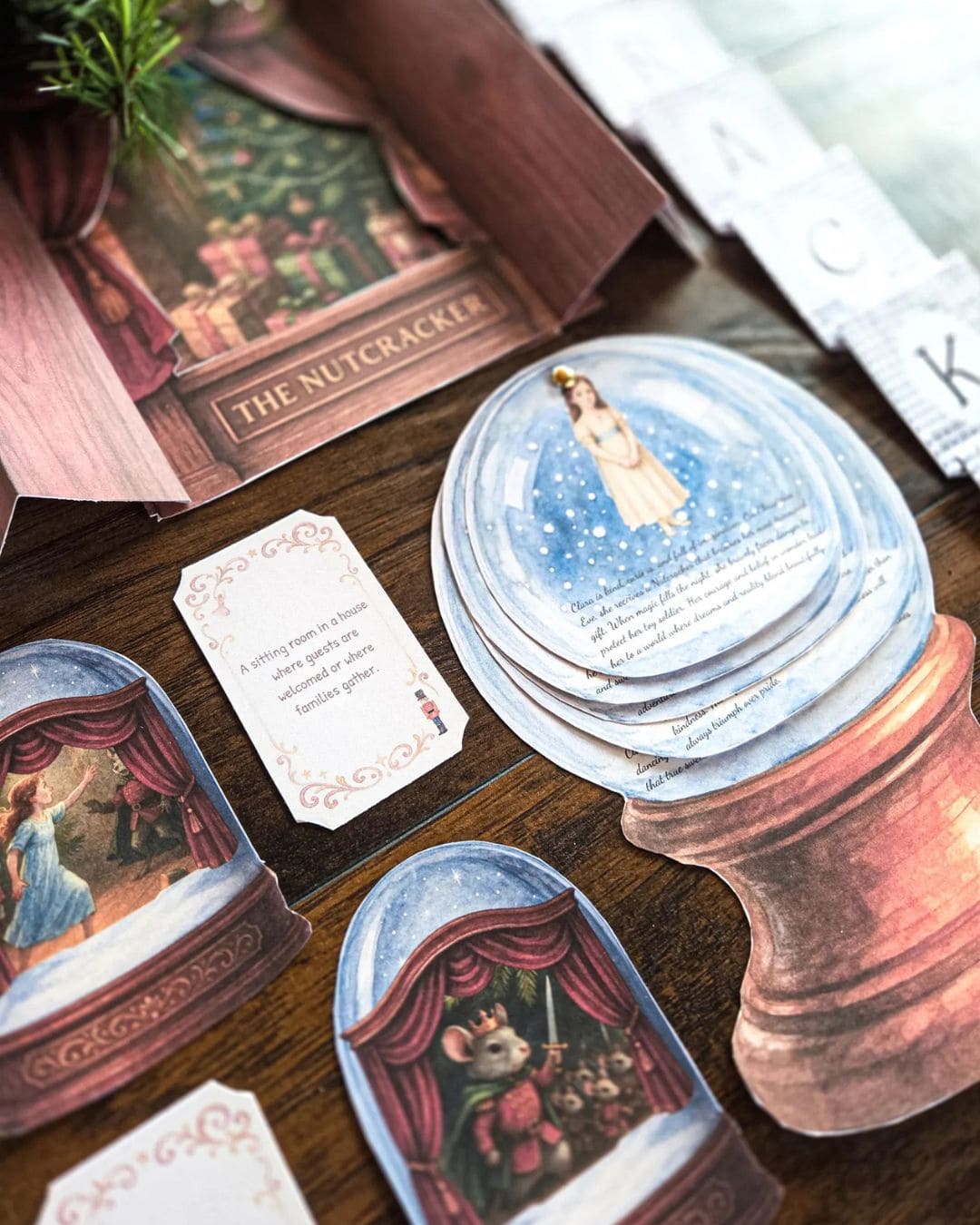 Card game components including cards and a box labeled 'The Nutcracker' on a wooden surface.