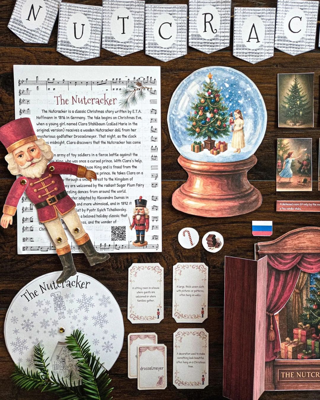 Collection of Christmas-themed items including a Nutcracker figurine, snow globe, and decorative cards on a wooden surface.
