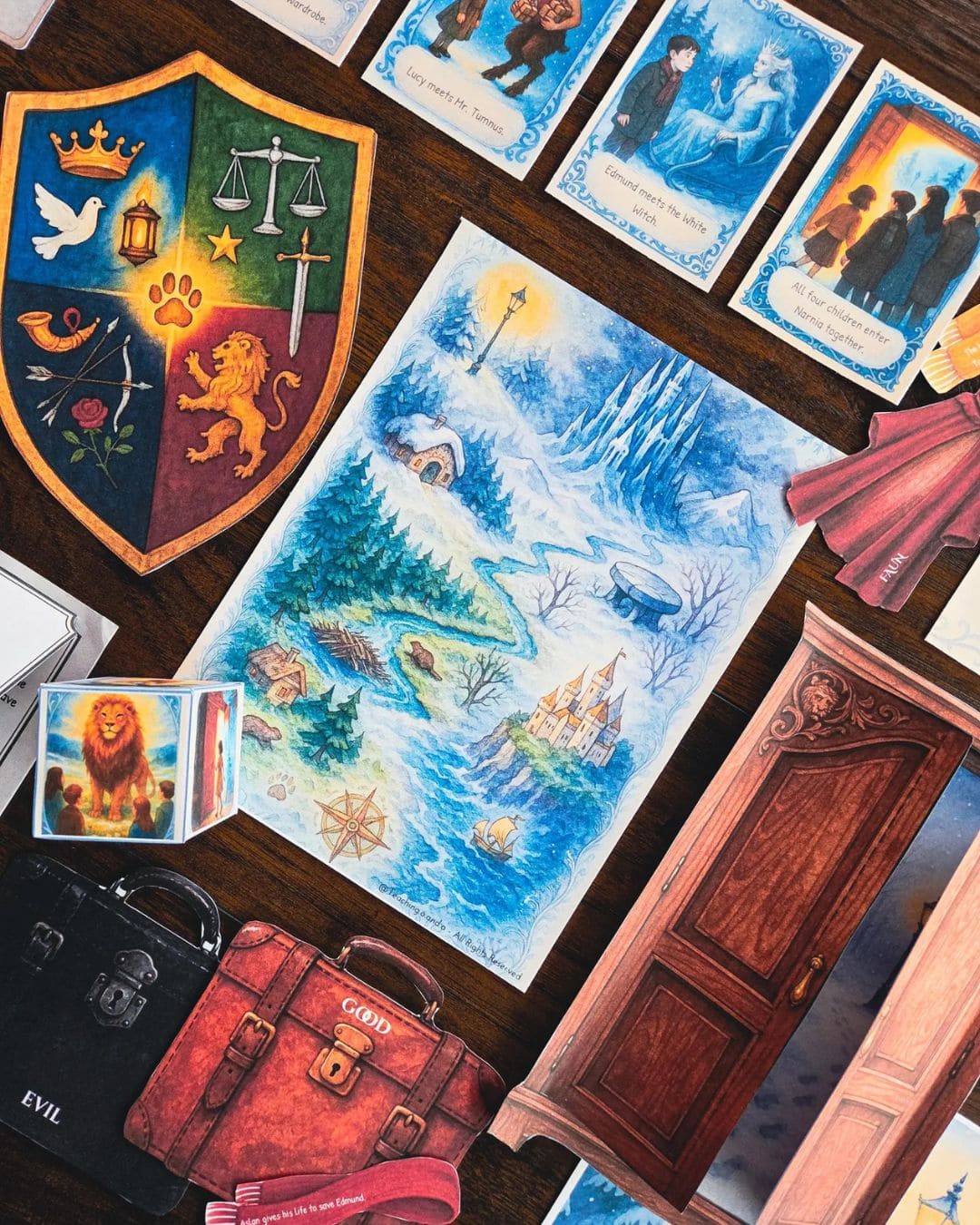Close-up of Narnia homeschool activities featuring shields, map, wardrobe scene, and watercolor accents
